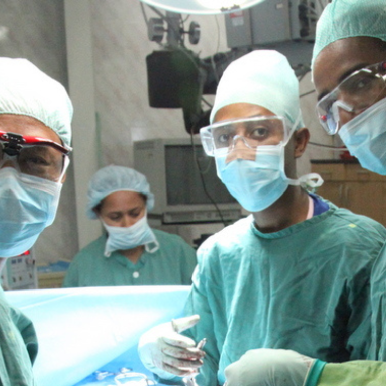 Healthcare professionals posing for a photo right before surgery.